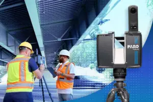 Two construction workers in hi-vis vests and hard hats operate surveying equipment at a construction site, with a Faro laser scanner on a tripod nearby.